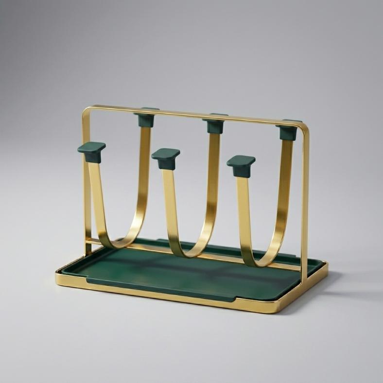 A Nordic minimalist 6-cup drying rack featuring a flat gold metal U-shaped frame, an emerald green removable drip tray, and matching green protective square caps on the hooks.