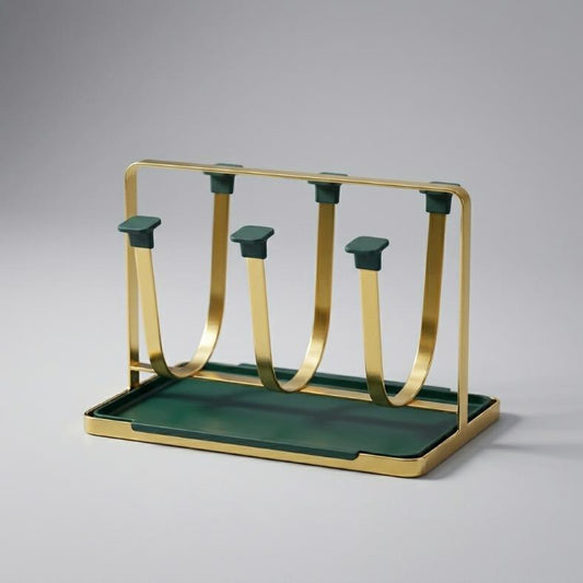A Nordic minimalist 6-cup drying rack featuring a flat gold metal U-shaped frame, an emerald green removable drip tray, and matching green protective square caps on the hooks.